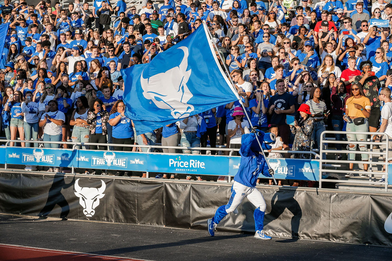 UB Mascot Running with Flag in Front of Crowd
