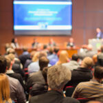 A conference room full of people at an Ellicott business conference venue as they provide a checklist for planning your business conference