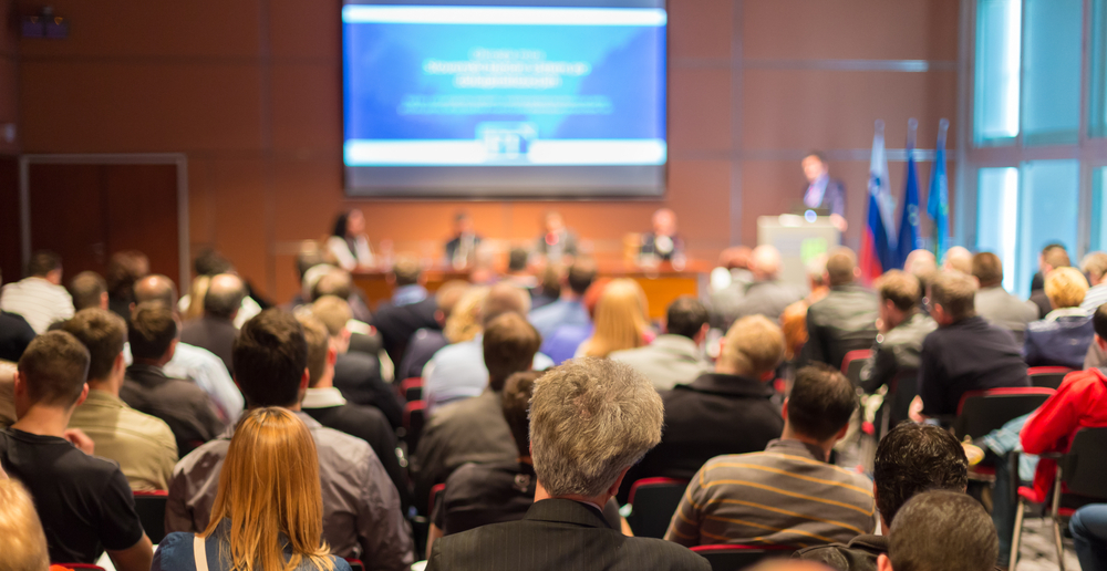 A conference room full of people at an Ellicott business conference venue as they provide a checklist for planning your business conference