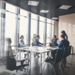 A business meeting of executives in an office about the commercial business economic growth in Buffalo during 2021