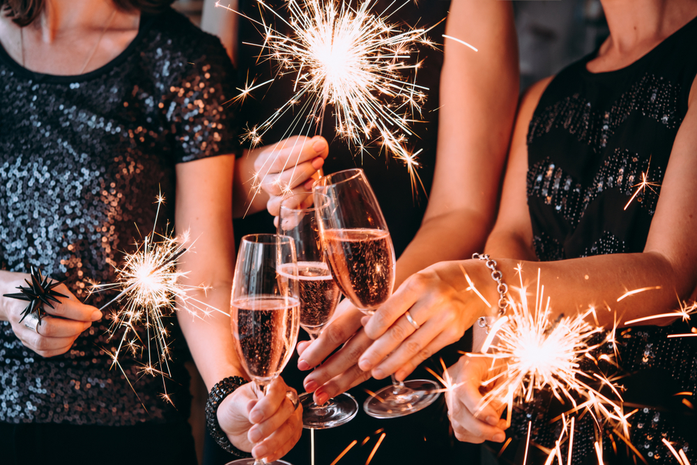 A group of people holding sparklers and flutes of champagne celebrate the new year in Buffalo, New York