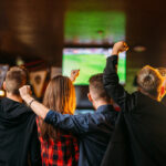 A group of fans cheer for the Buffalo Bills at a Buffalo Bills Fan Bar in Buffalo, NY
